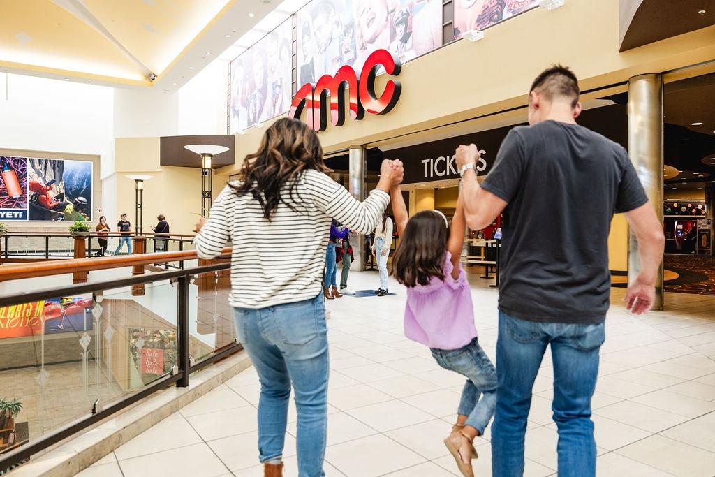 A family in the mall outside an AMC theater