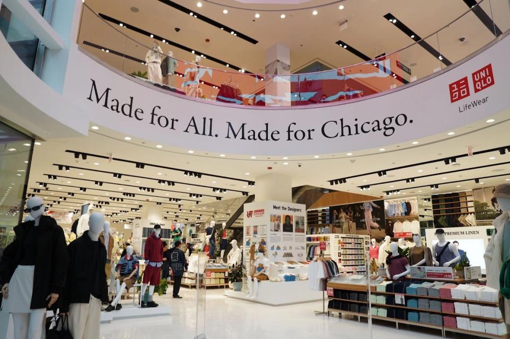 Modern style interior of brightly lit two-story corporate clothing store