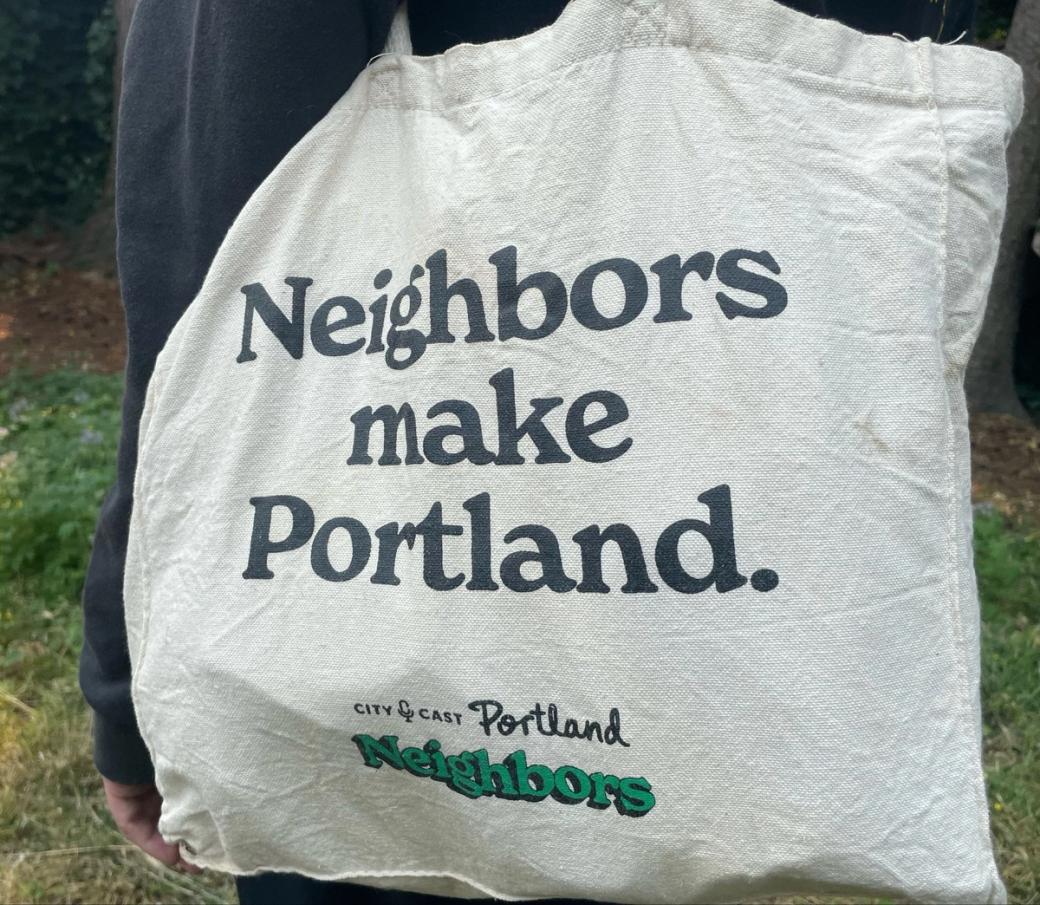 off-white canvas tote bag that reads “Neighbors make Portland. / City Cast Portland Neighbors”