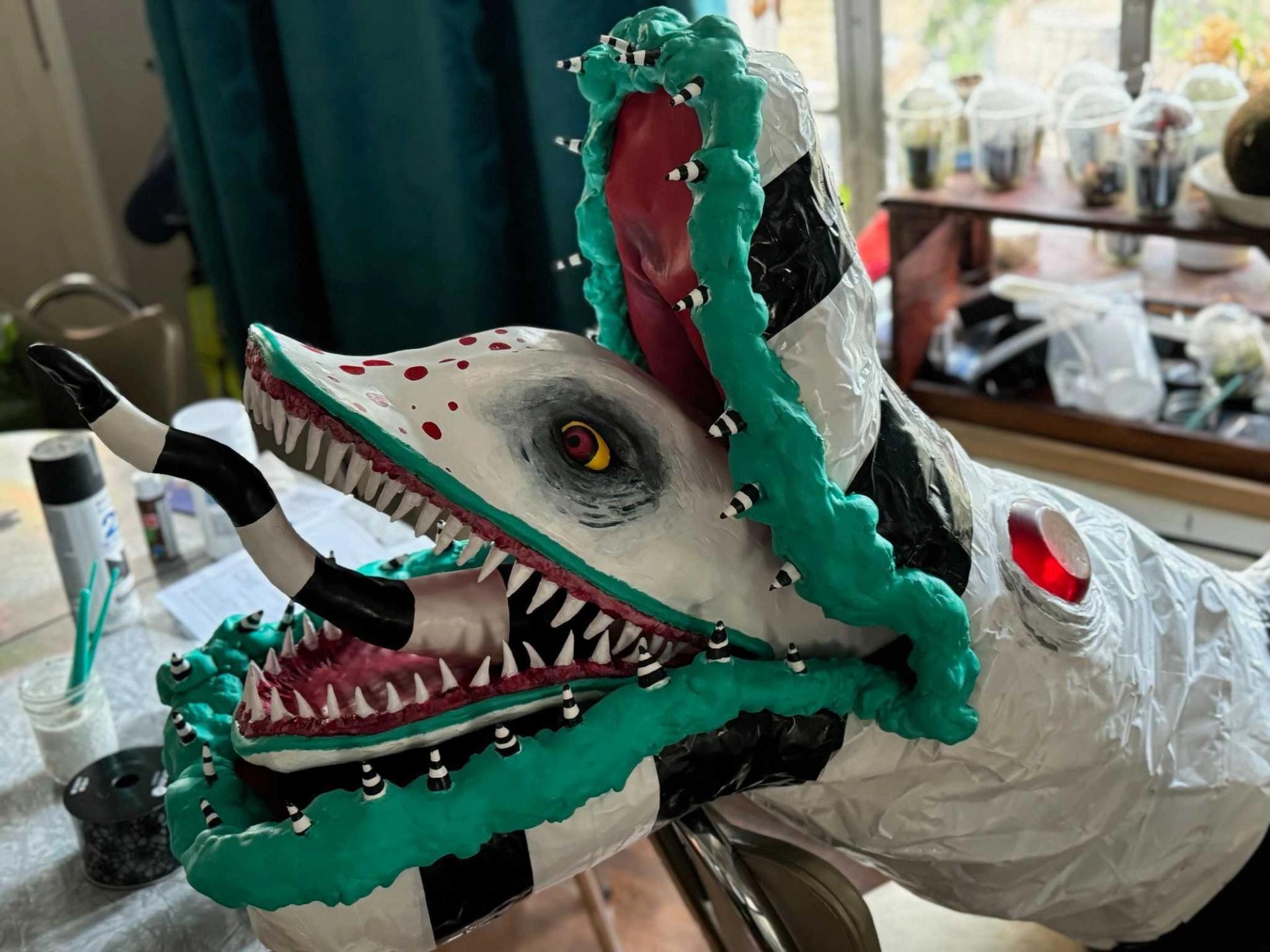 A homemade sandworm. Sandworms are big, white snakelike creatures in the movie "Beetlejuice." It has turquoise lips, red eyes, and black stripes.