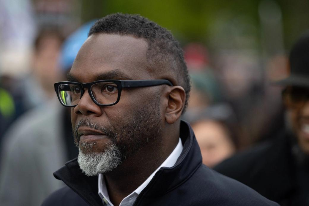 A man in glasses looking off camera