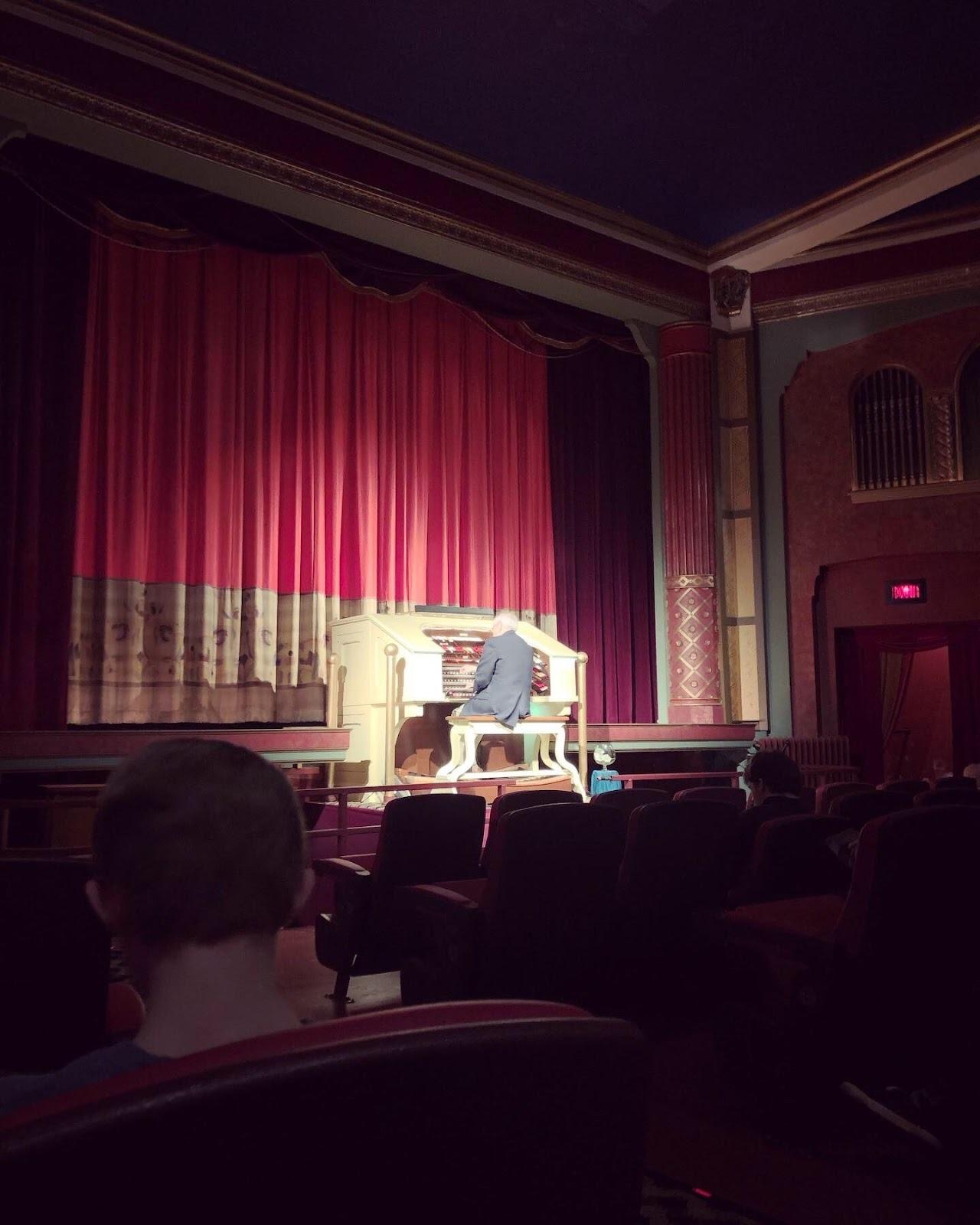 A man playing an organ on stage