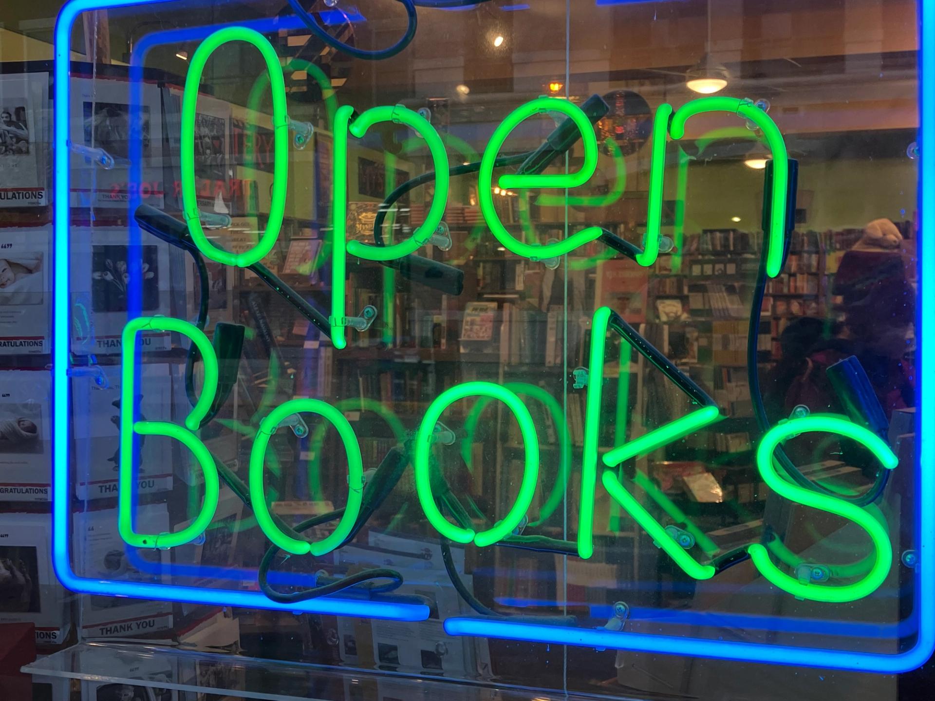 A green and blue neon sign.