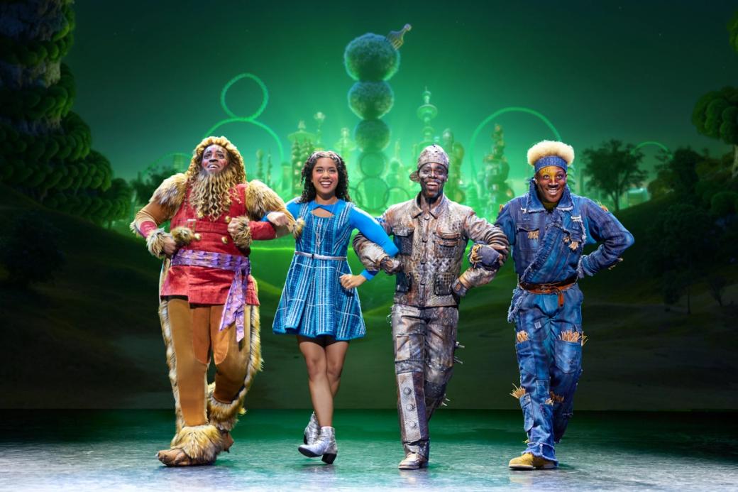 Four people dressed in costumes from "The Wiz."