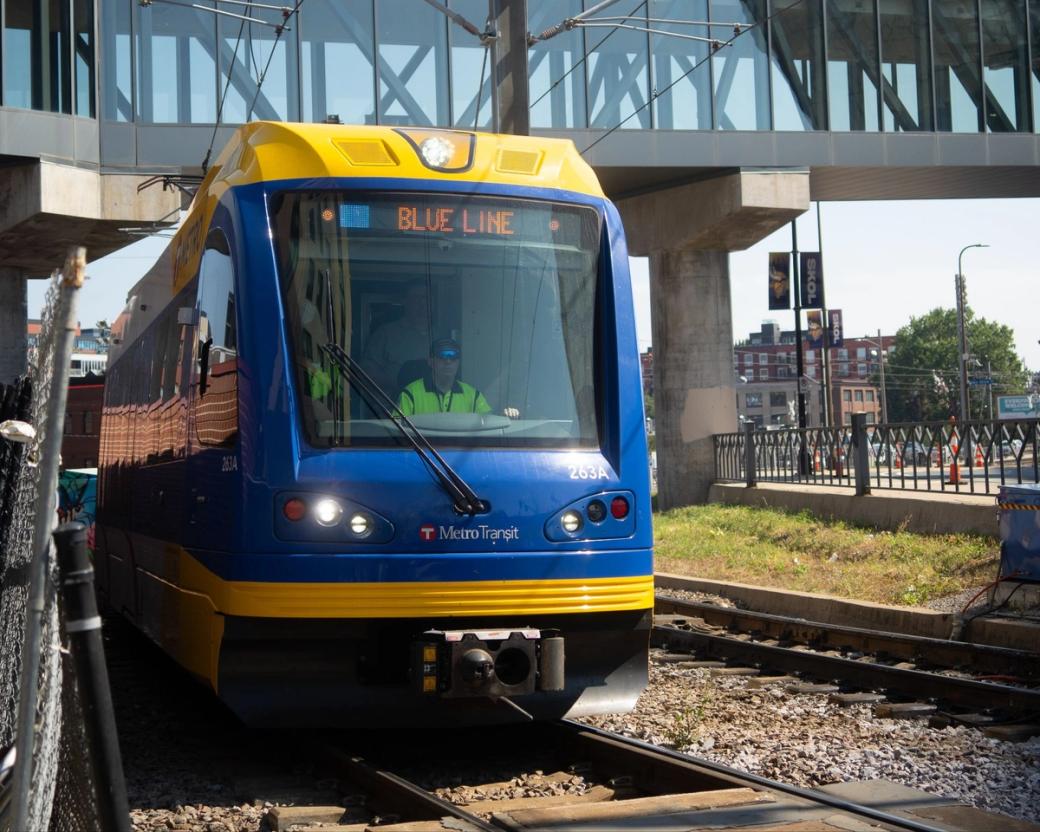 Eye-level view of the front of a train car with conductor driving