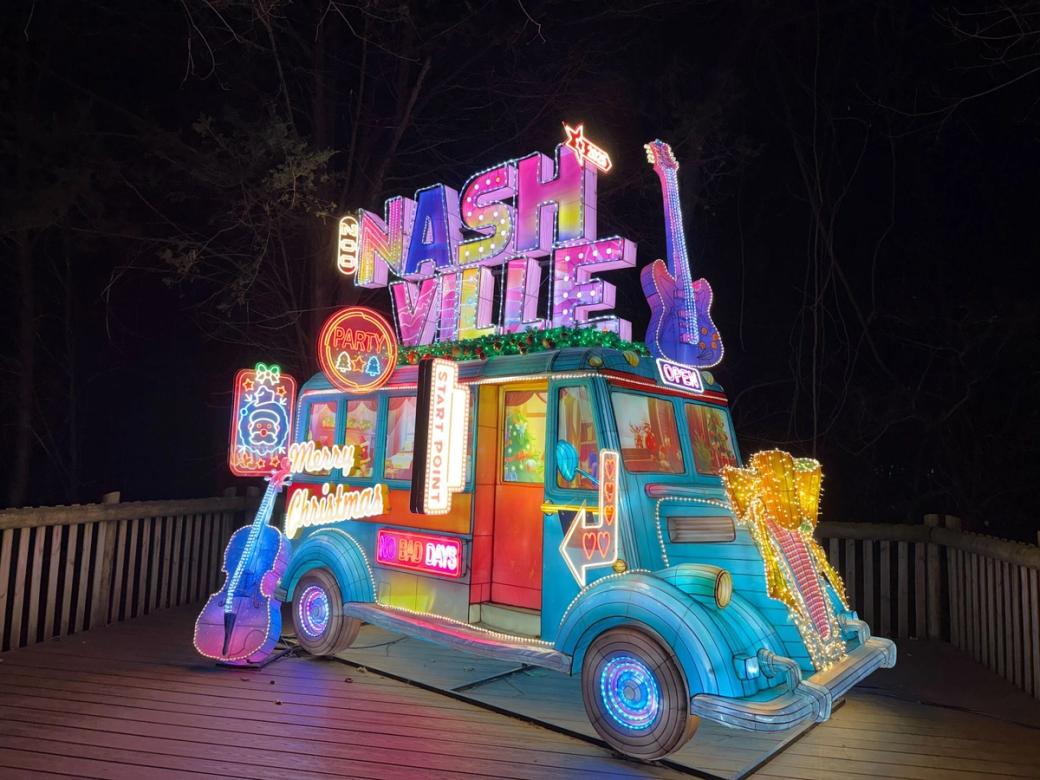 A blue bus made out of a glowing lantern with the text NASHVILLE on top and guitars.