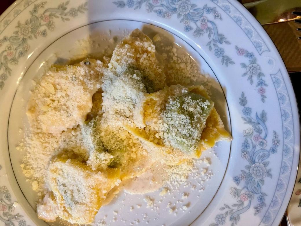 A plate of pasta covered in parmesan cheese