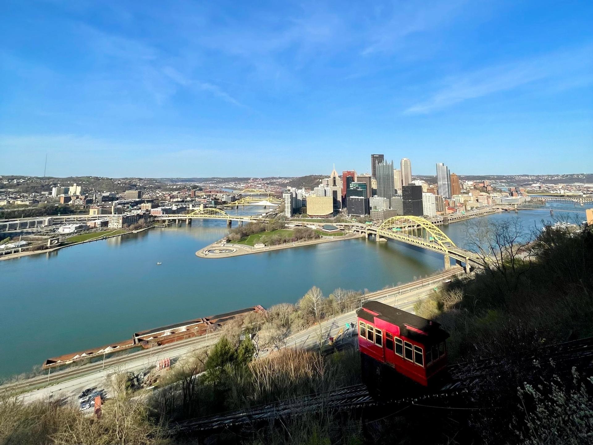 a view of a city skyline and a funicular railway
