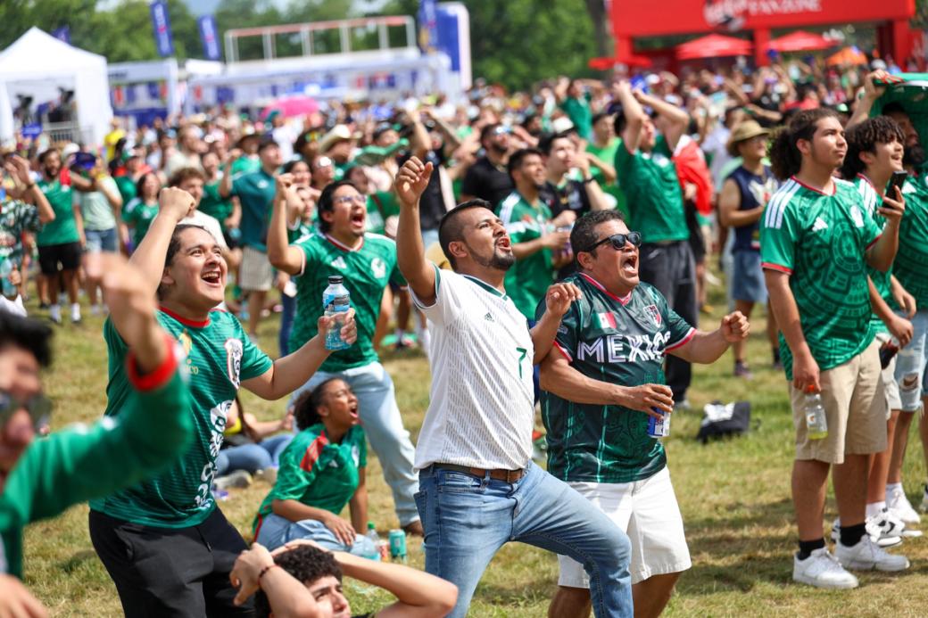 Fans sit and stand at Lemon Hill watching the World Cup