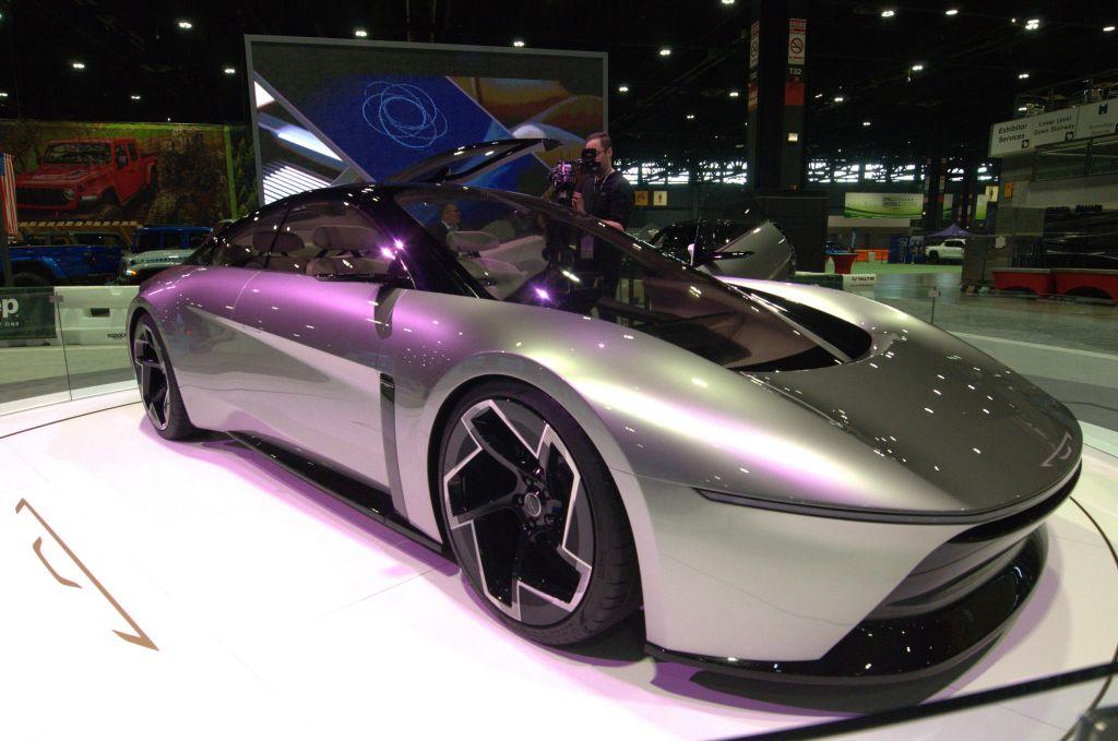 Silver concept car with wing doors.