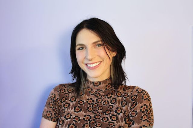 Grace Fuiz, wearing a flower patterned top, poses for a headshot. 