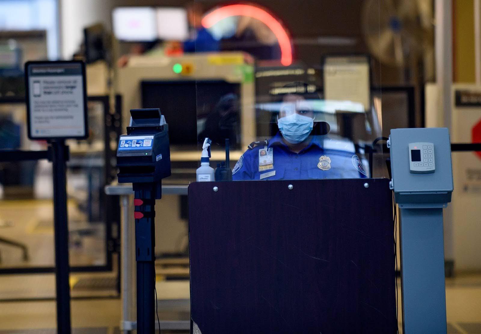 TSA agent behind glass at the Pittsburgh International Airport