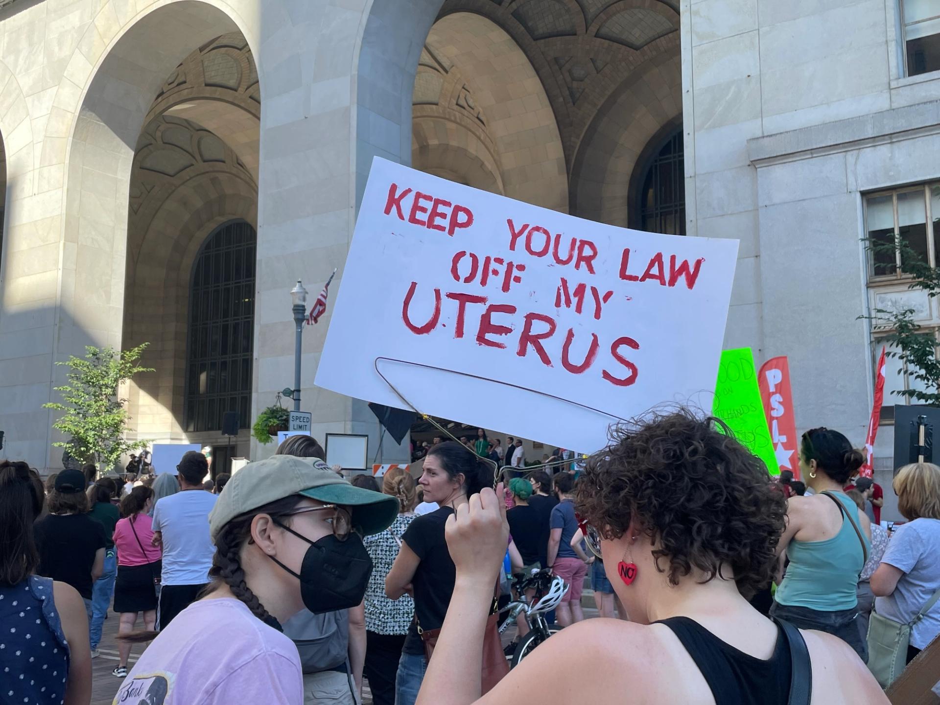 A Pittsburgh protester holds a sign reading “KEEP YOUR LAW OFF MY UTERUS” at a rally Downtown, June 24, 2022, following the overturn of Roe v. Wade. (Francesca Dabecco / City Cast Pittsburgh)