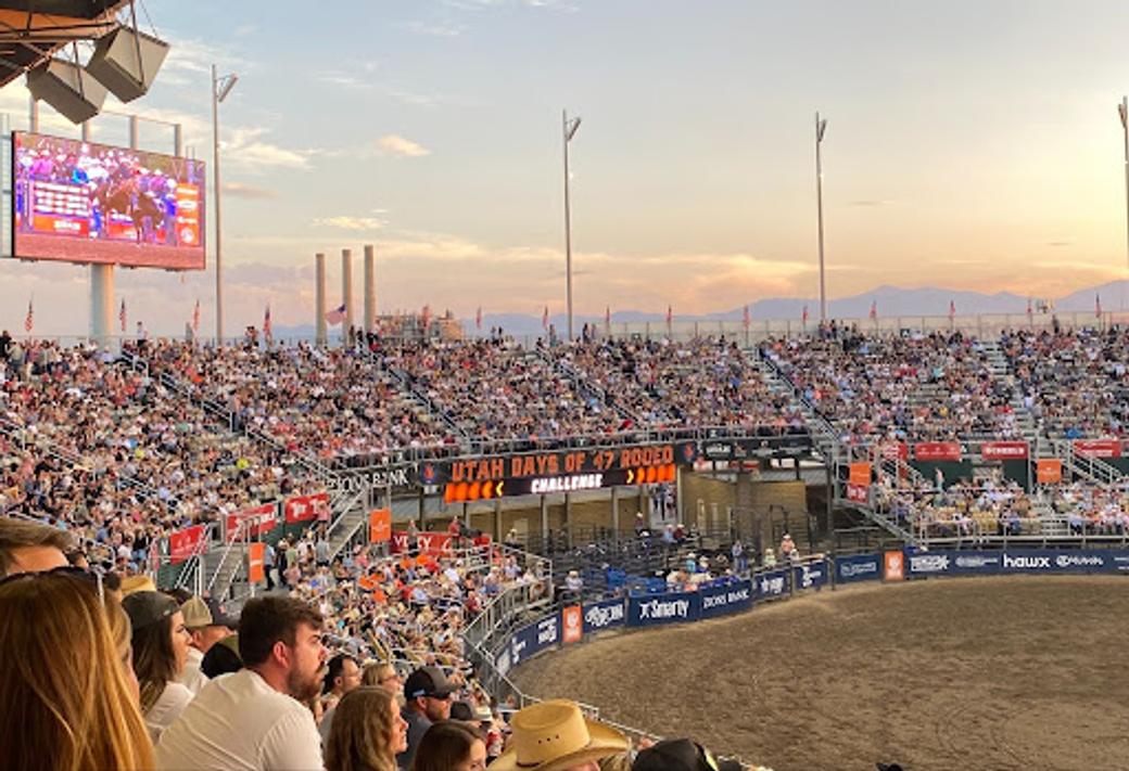 A packed crowd fills the stands at the Utah Days of ‘47 Rodeo in Salt Lake City at sunset. 