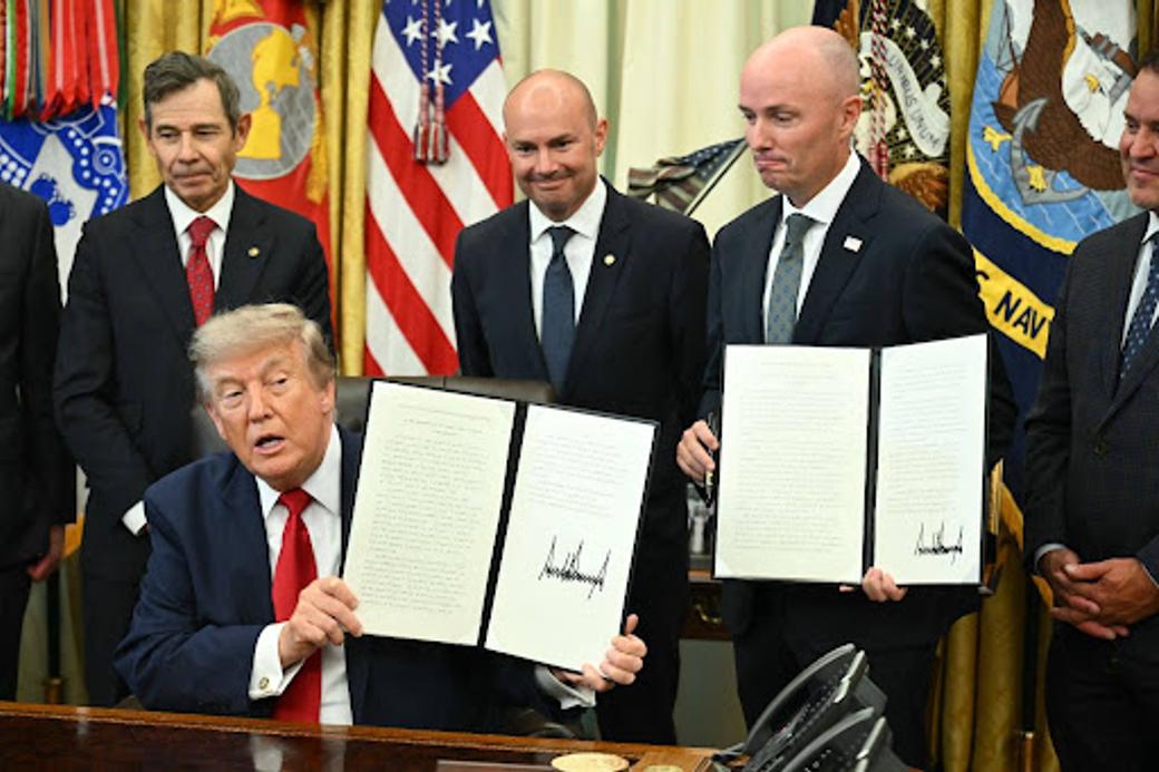 President Donald Trump and Utah Gov. Spencer Cox show executive orders Trump signed to drastically shrink two national monuments in Utah
