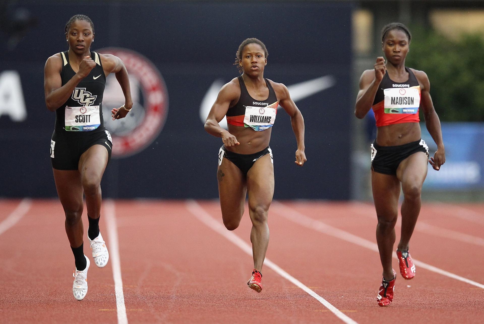 three women run on a track