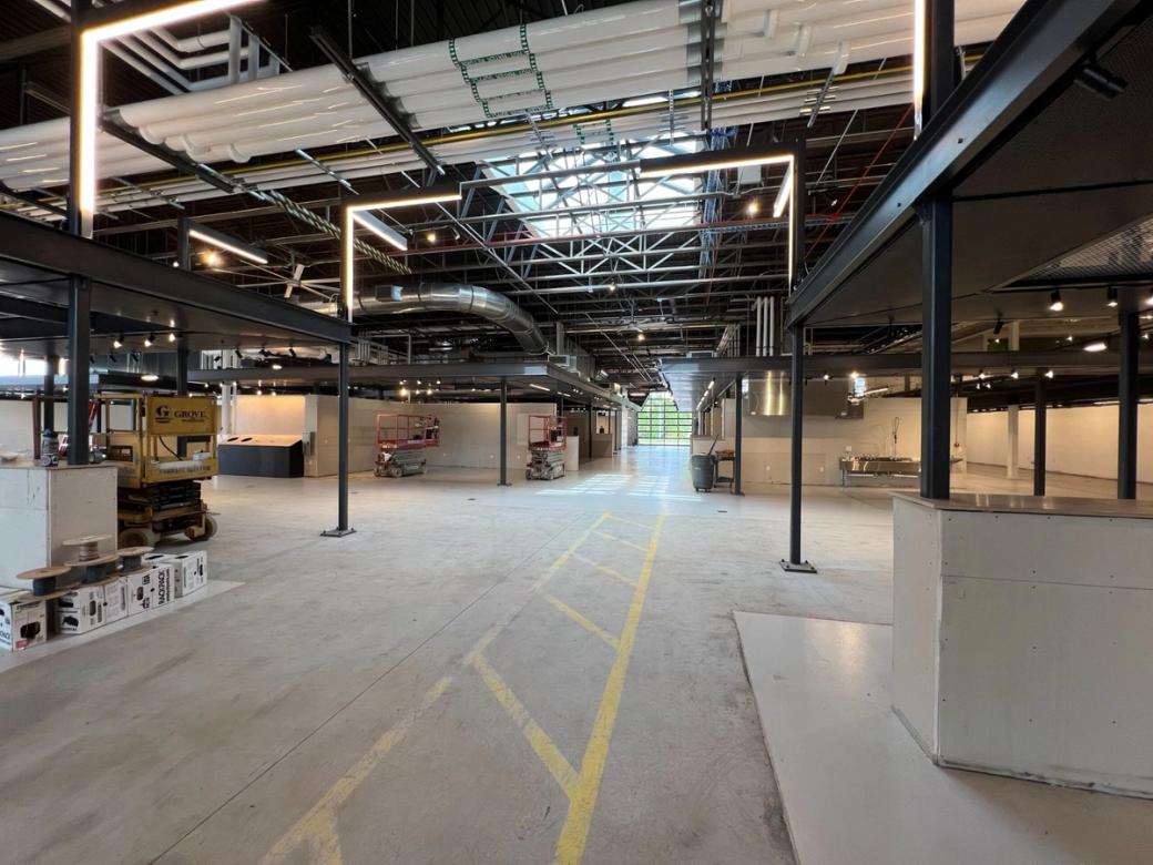 The inside of the Madison Public Market before it was completed. A large open space with steel beams and construction equipment.
