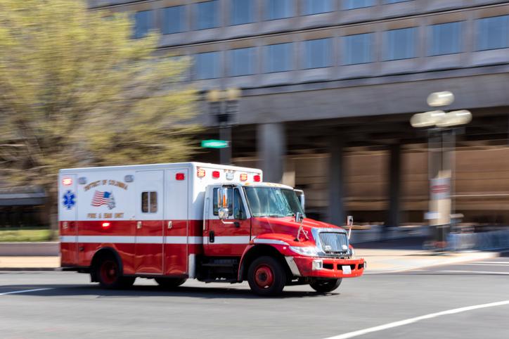An ambulance speeding past the FBI building