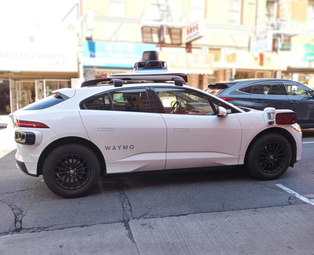 White Waymo vehicle in traffic