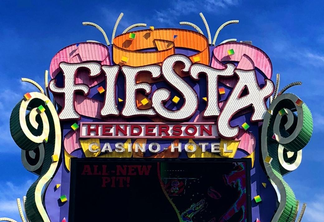 The sign for the Fiesta Henderson Casino Hotel - pink and orange streamers surround the word "Fiesta"..