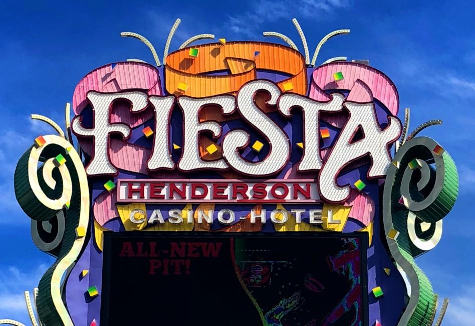 The sign for the Fiesta Henderson Casino Hotel - pink and orange streamers surround the word "Fiesta"..