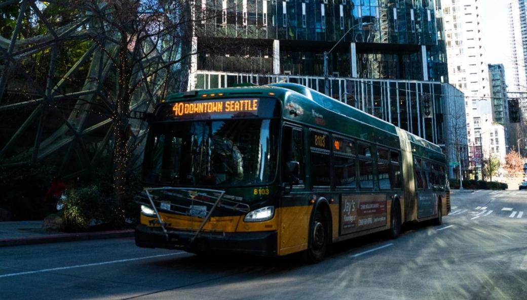 A Route 40 bus reading “Downtown Seattle” on its LED sign drives past the Amazon spheres in South Lake Union.