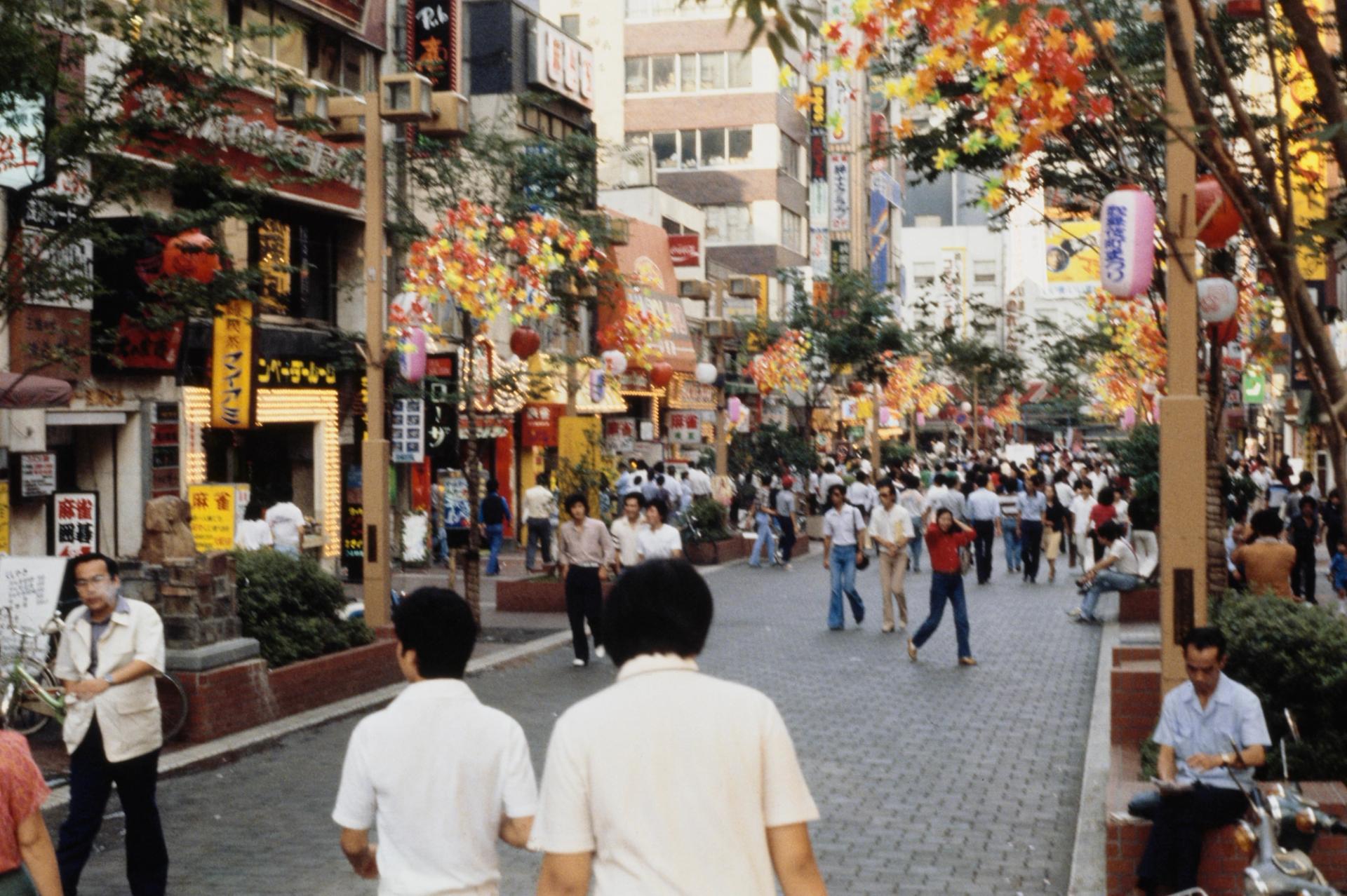 A bunch of people walking in a busy tokyo street