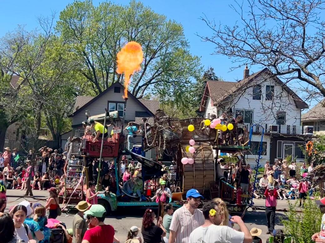 A group of people surrounding a float during a parade