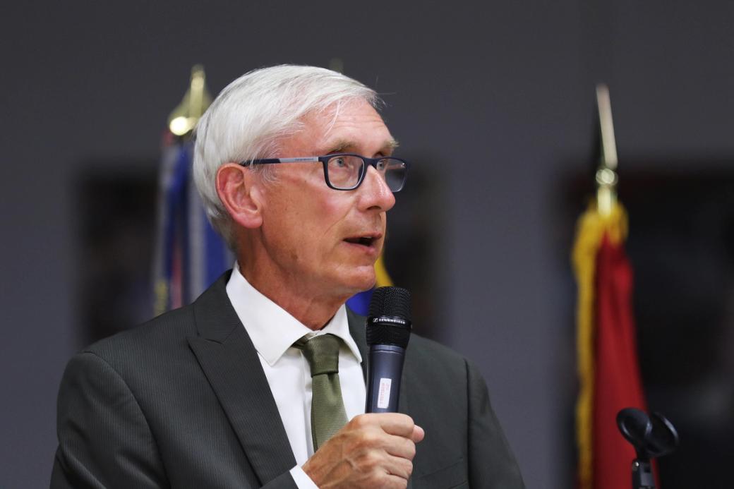 A man with white hair in a suit and tie.
