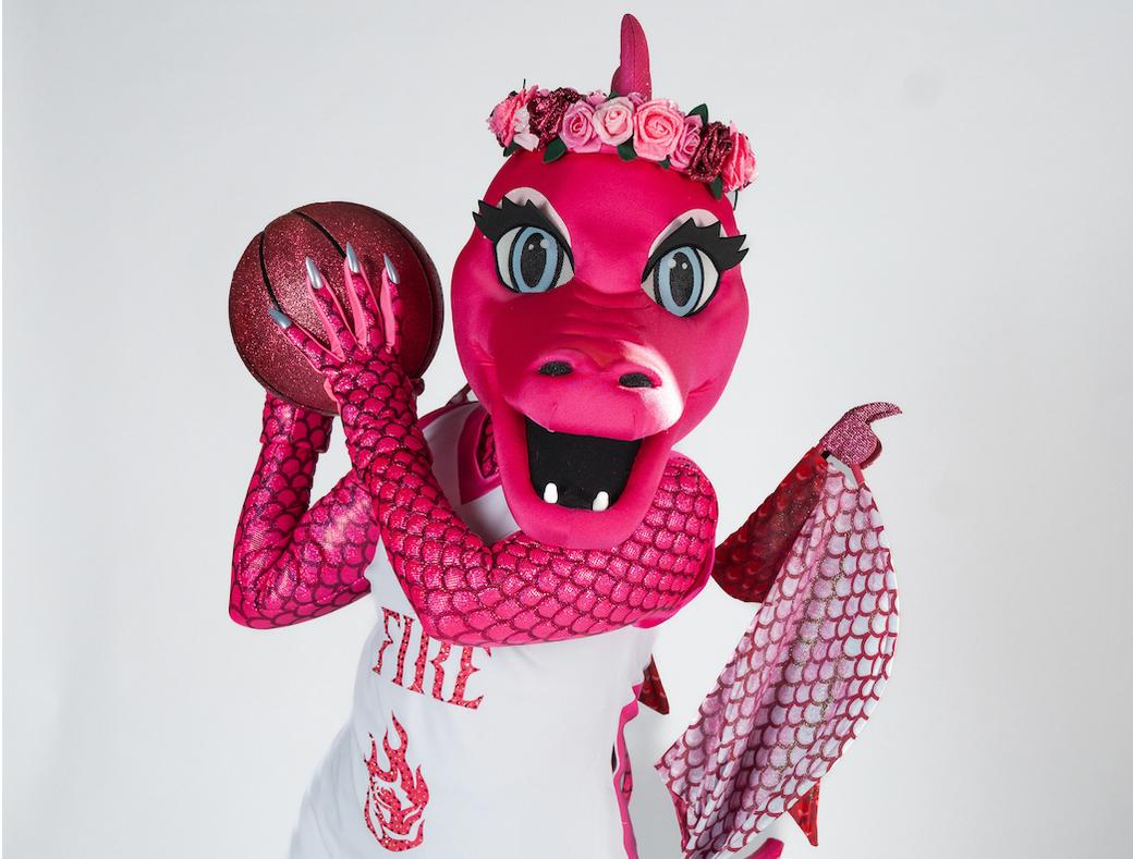 Pink dragon in a Portland Fire jersey, holding a basketball in front of white background