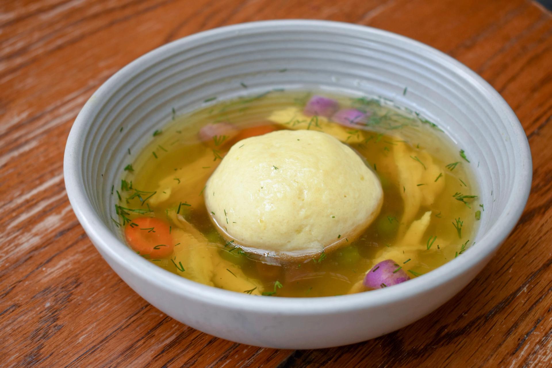 A bowl of matzo ball soup.