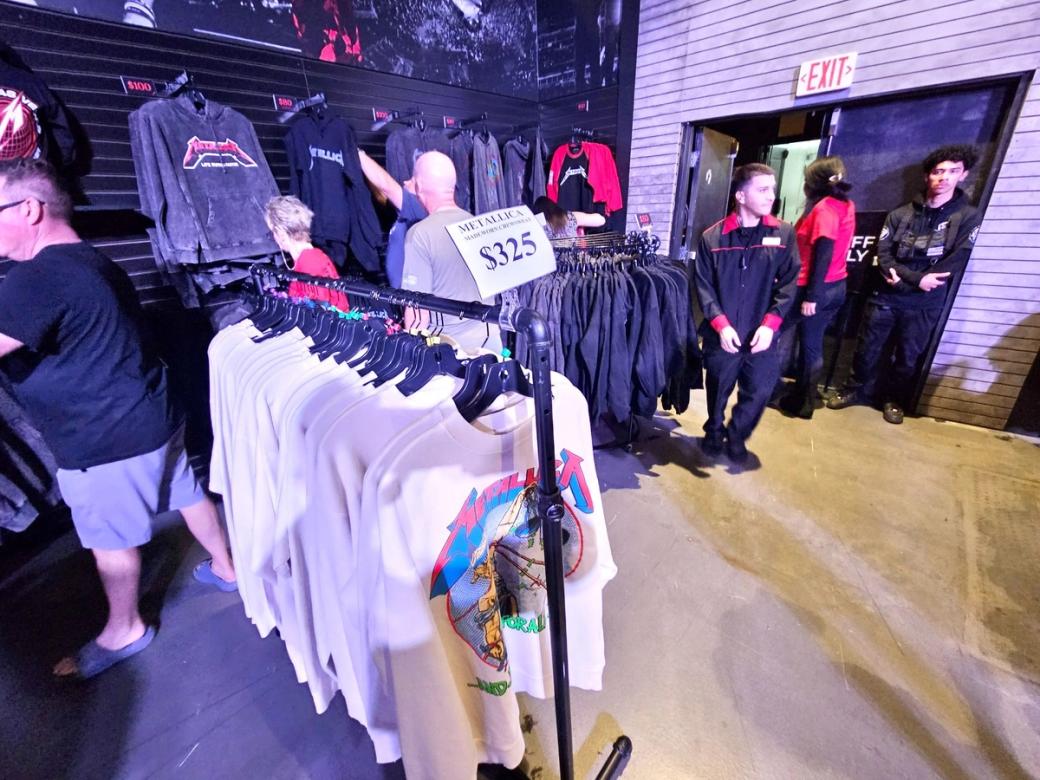 A rack of Metallica t-shirts inside a pop-up store.