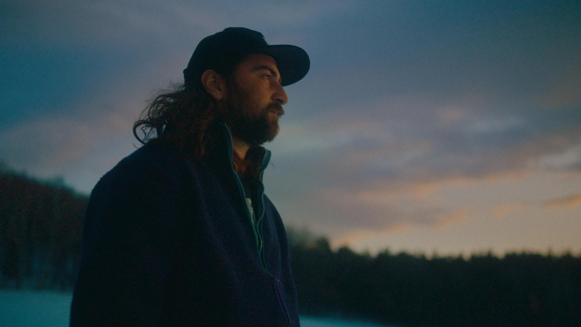 Noah Kahan wearing a baseball cap.