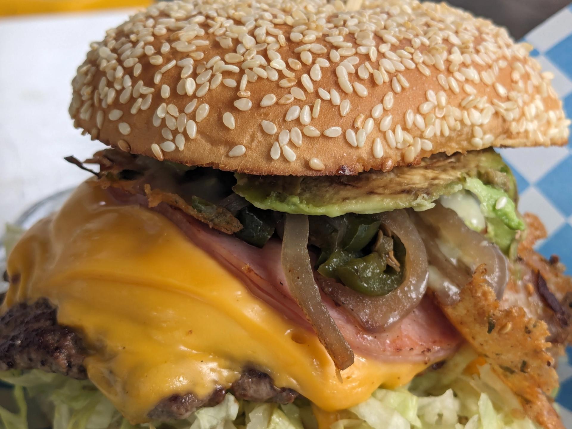 hamburger loaded with cheese, onions, lettuce, and topped with a sesame seed bun, Portland, Oregon