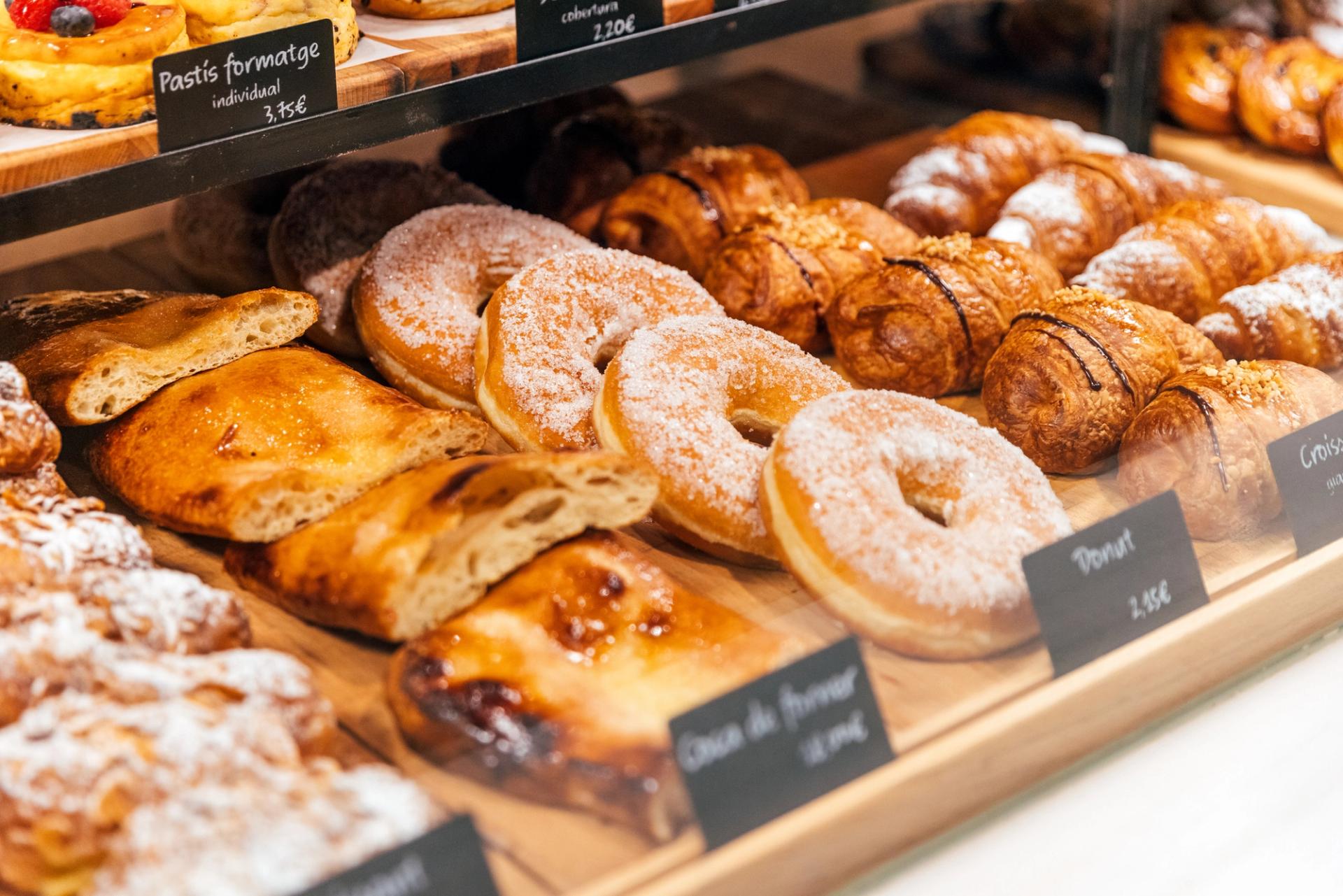 Fresh baked goods sit in a bakery display window