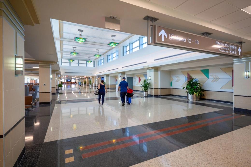 Travelers walk in the mostly empty South Terminal at the Dane County Regional Airport.