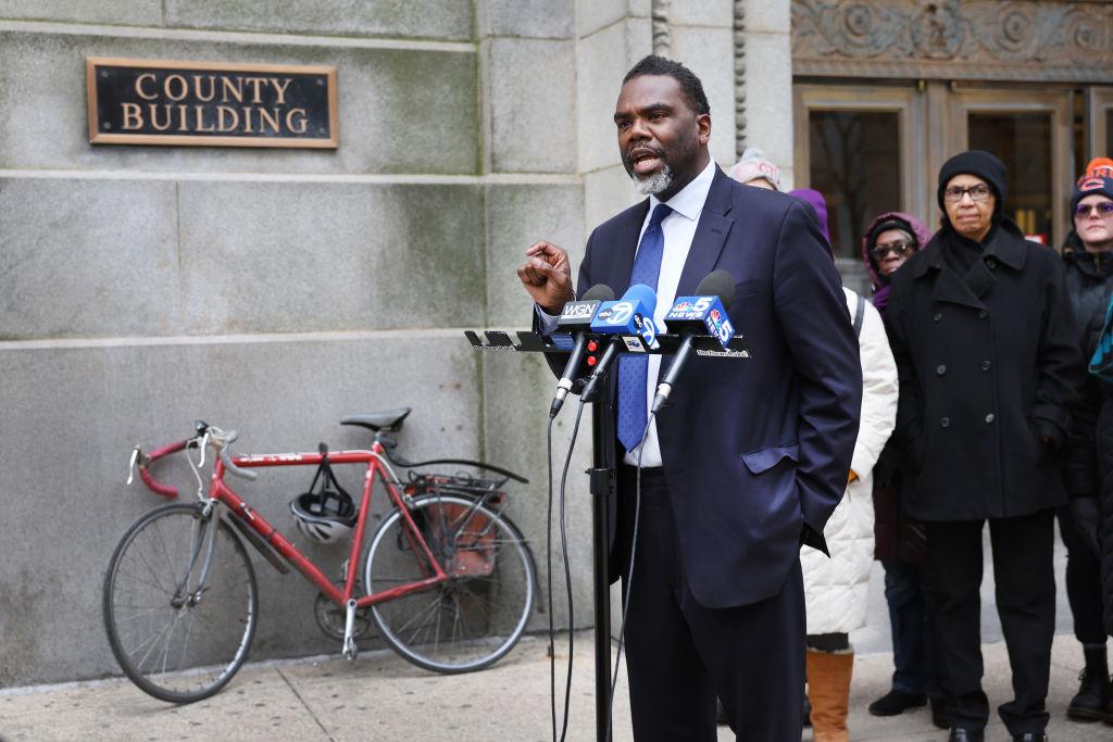 Brandon Johnson speaks in front of microphones