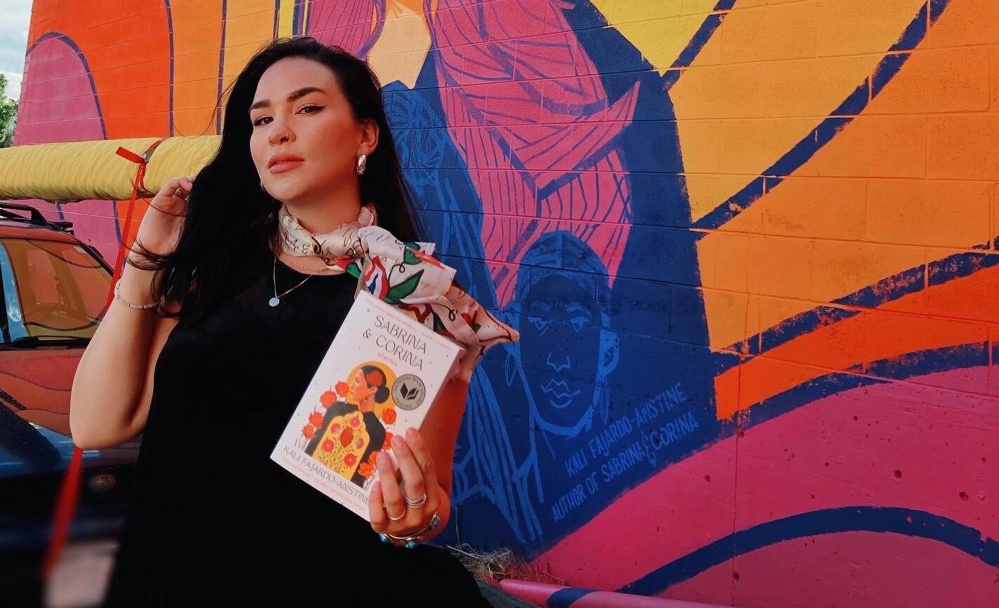 Award-winning Denver author Kali Fajardo-Anstine poses with her collection of short stories, “Sabrina & Corina.”