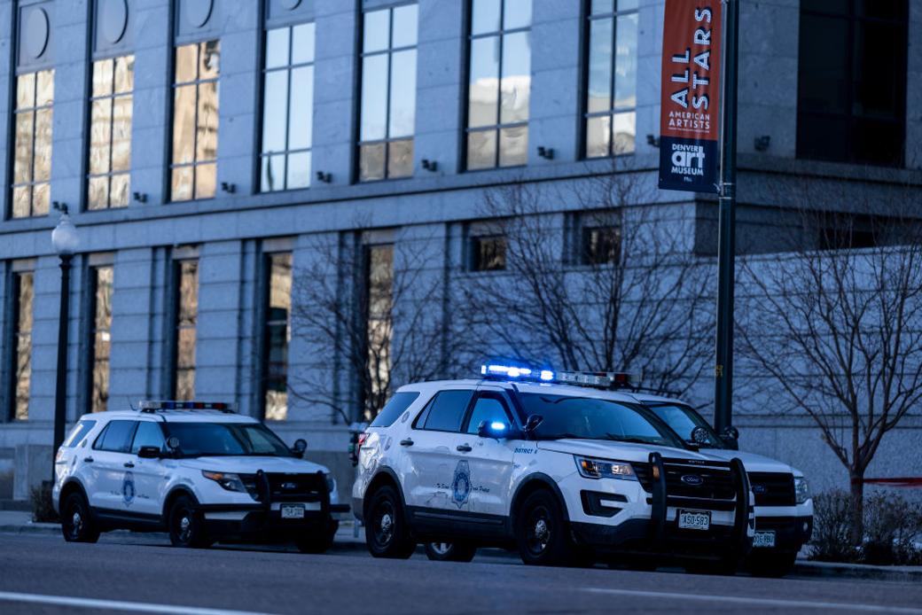 Police car in traffic at nighttime in Denver