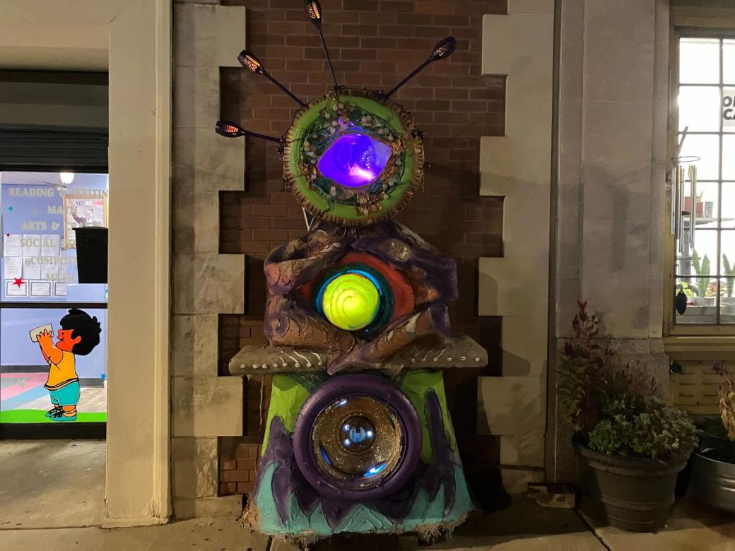 A glowing, multi-color sculpture resembling eyes
