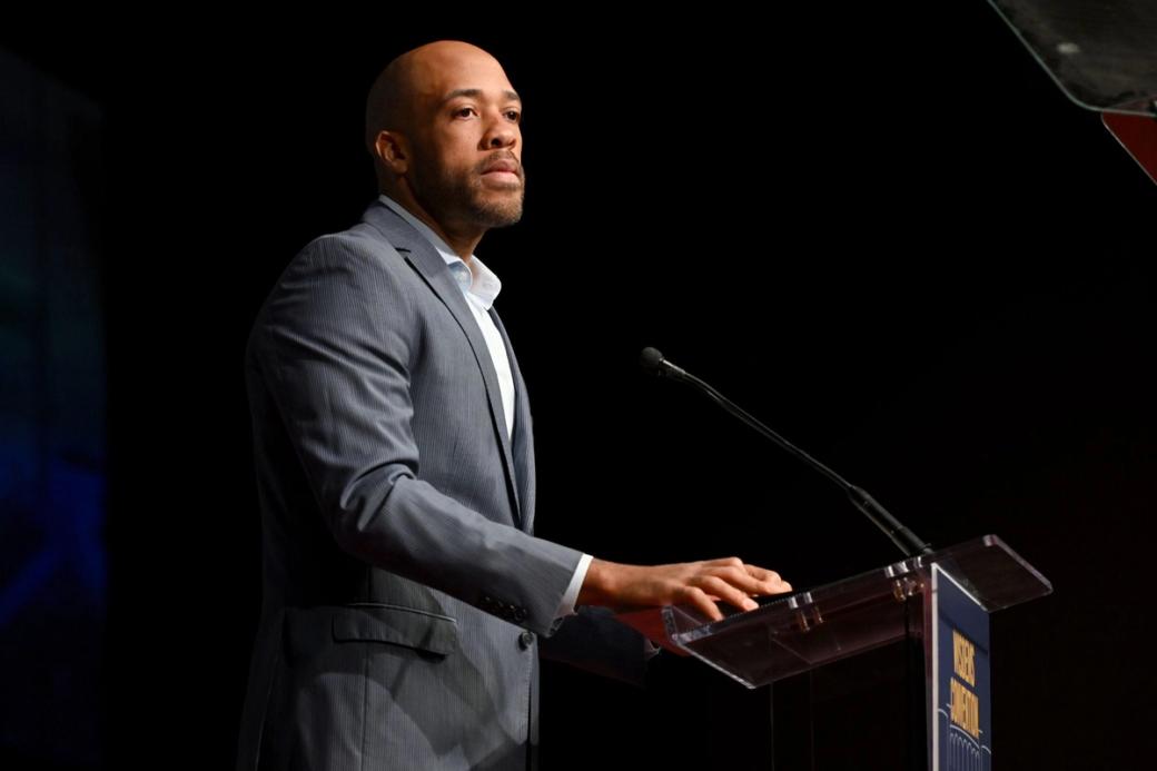 Mandela Barnes stands at a podium.