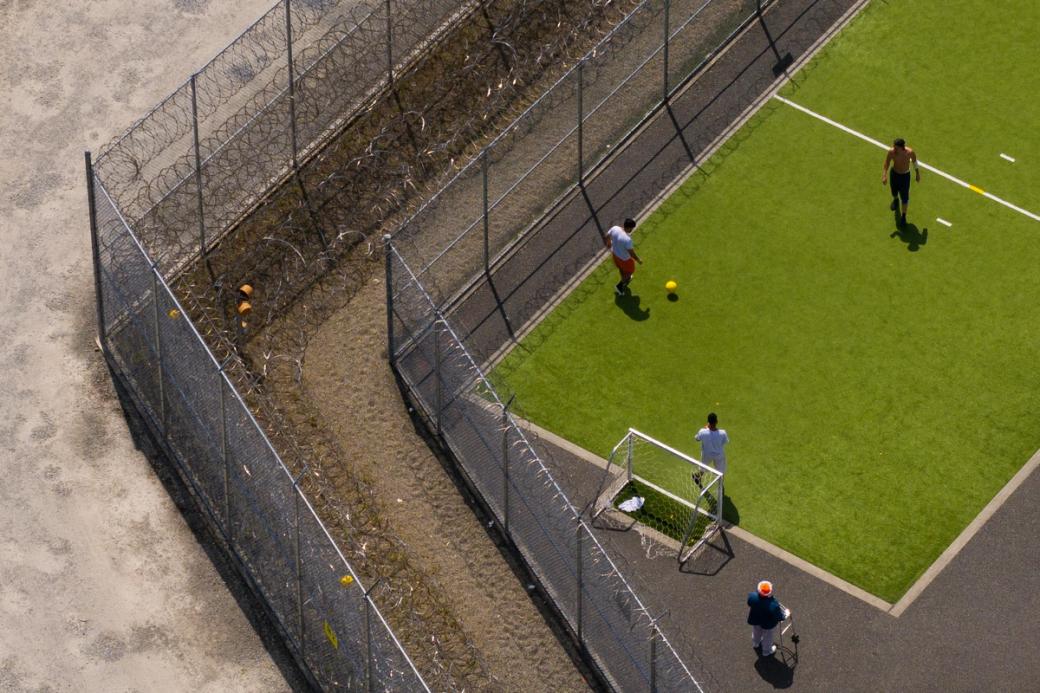 An image of people playing soccer within the Northwest Detention Center in Tacoma