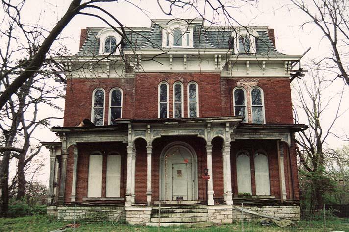A two-story red-brick mansion surrounded by trees and grass in Alton, Illinois.