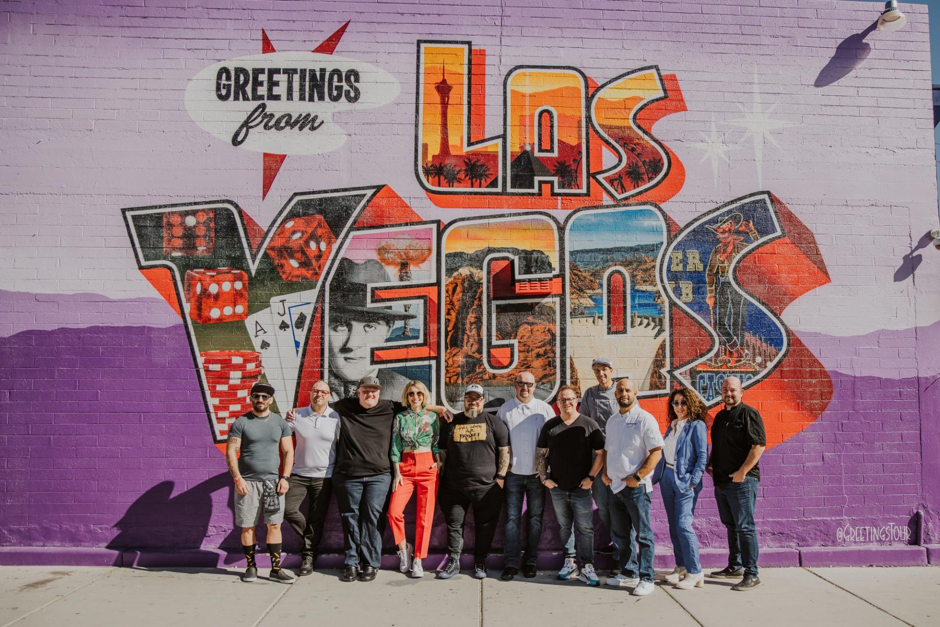 Las Vegas chefs standing next to an art mural.