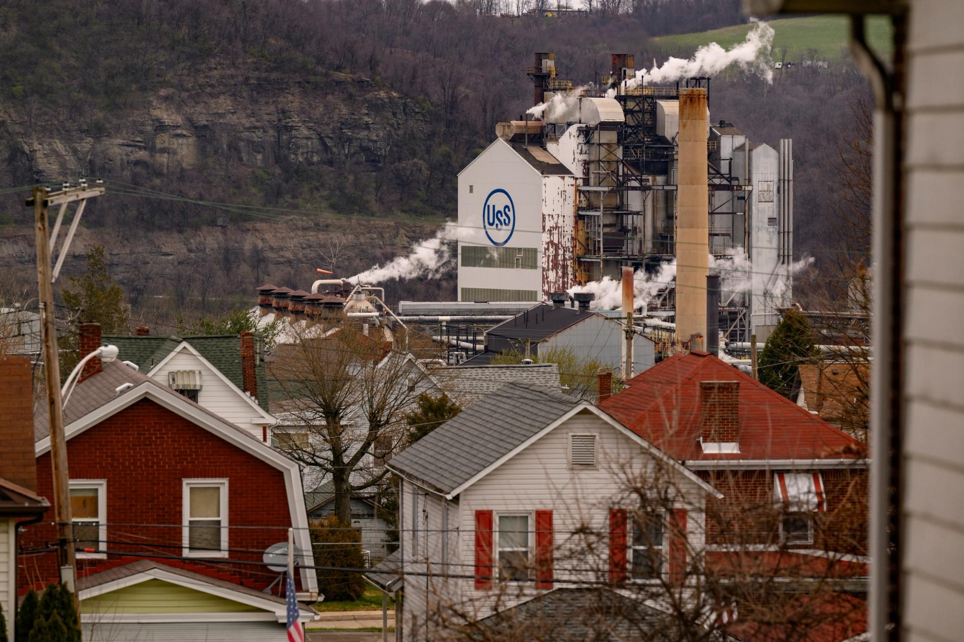 a coke works behind a hill of houses