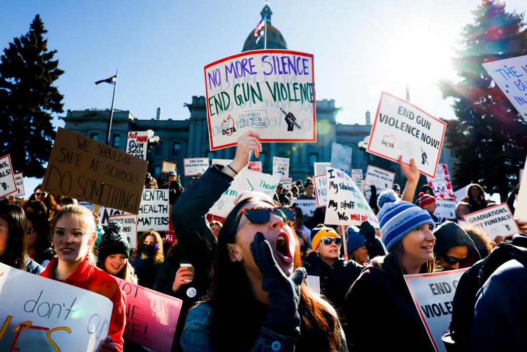 Protestors outside Colorado State Capitol hold signs condemning gun violence