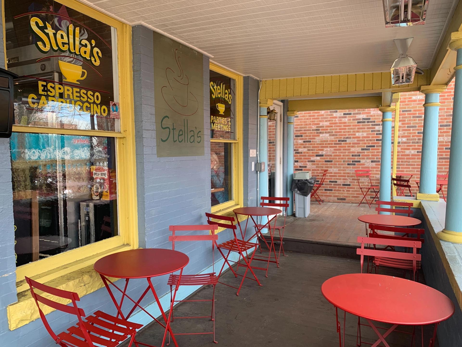 The patio at Stella’s Coffee Haus, complete with red tables and chairs.