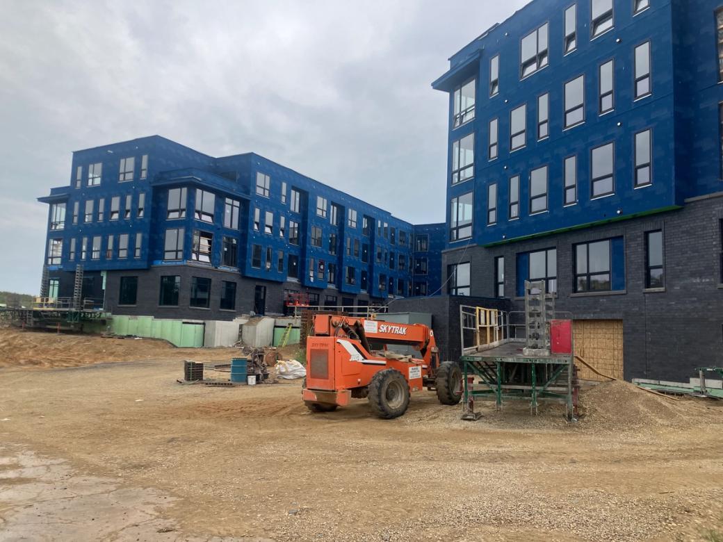 Two large blue buildings under construction.
