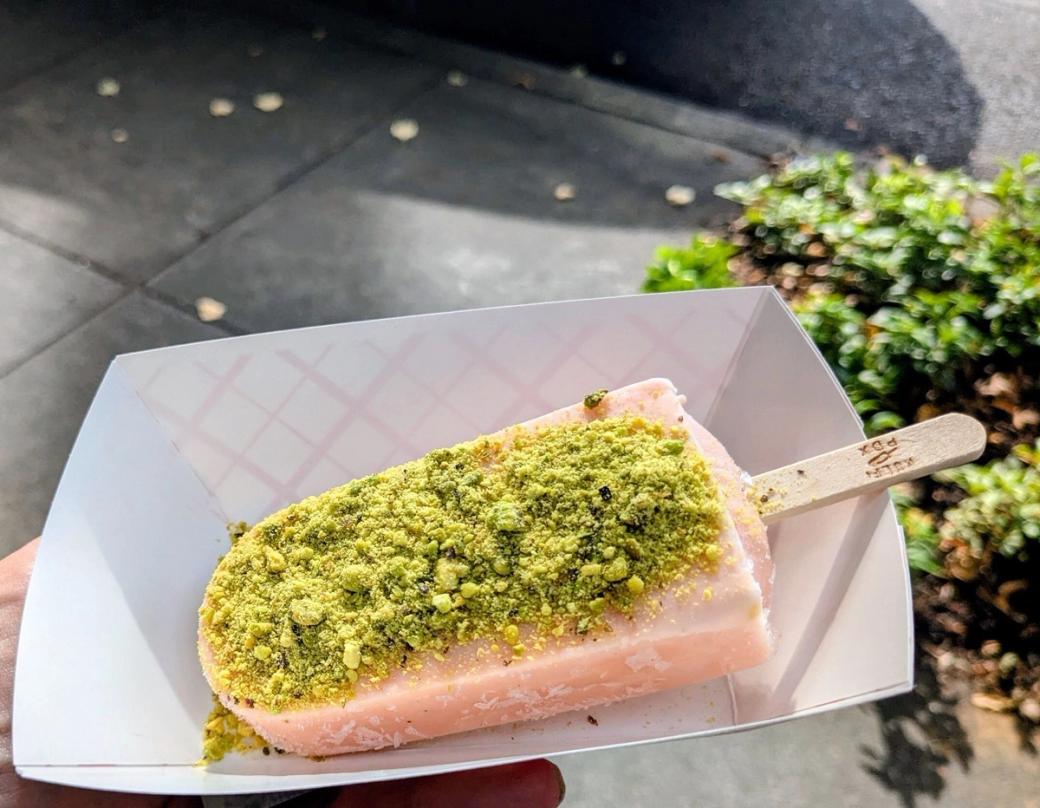 Pink popsicle with green pistachio crumble on top