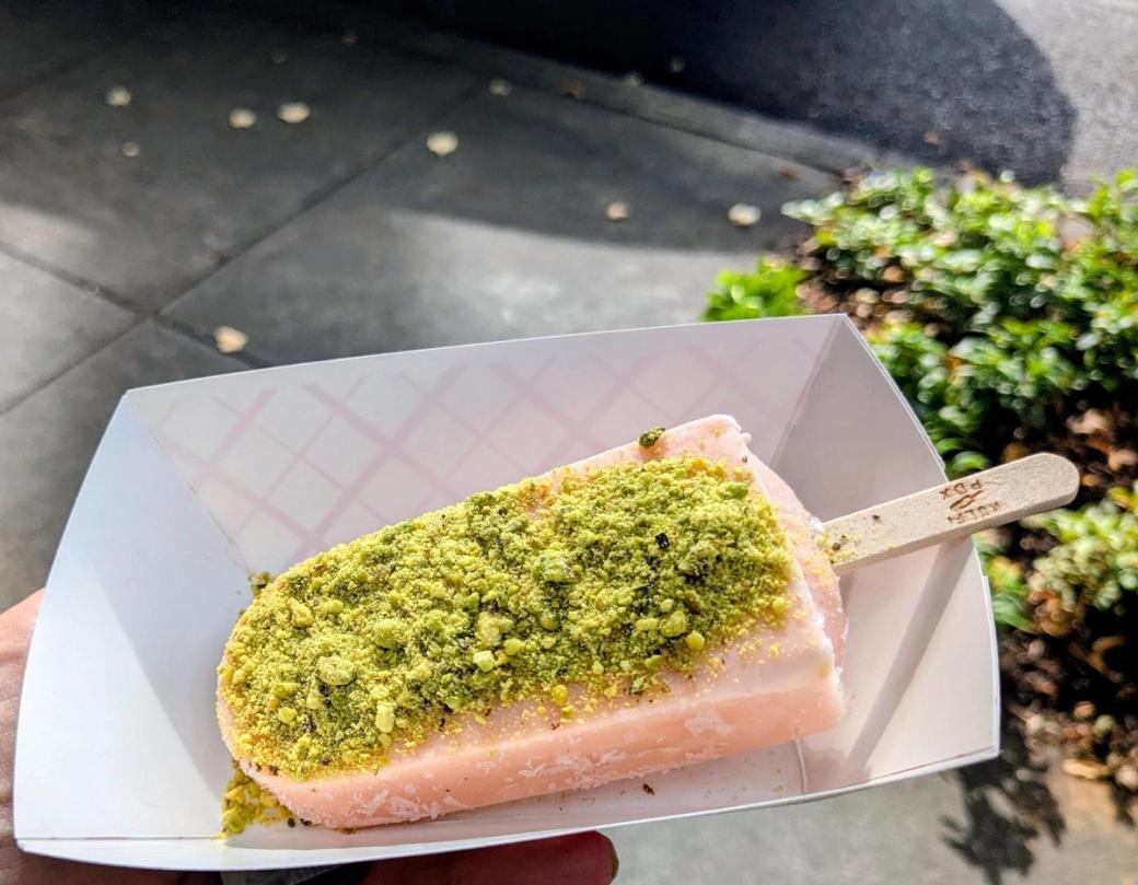 Pink popsicle with green pistachio crumble on top